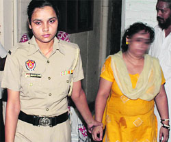 Kavita, wife of Rakesh Kumar, who committed suicide, being rounded up by the police at Darjian Mohalla in Jalandhar on Wednesday