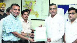 The owners of plots in illegal colonies get regularisation certificates from Chief Parliamentary Secretary KD Bhandari and Chief Administrator, Jalandhar Development Authority, Vinay Bublani in Jalandhar on Wednesday. 