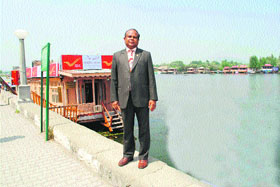 John Samuel, Chief Postmaster General, J&K circle, outside the floating post office on the Dal Lake in Srinagar.