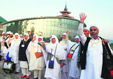 Kashmiri Haj pilgrims wave to their relatives before leaving for Mecca, in Srinagar.