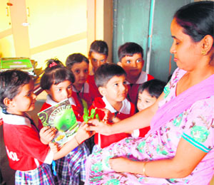 Schoolchildren present roses to their teacher during celebrations on Teacher's Day in Amritsar on Thursday.