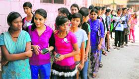 Girls wait to cast their votes in the students council elections at DAV (PG) College in Dehradun on Thursday.