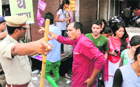 A police official asks students not to gather near DAV (PG) College in the wake of polling for the students council elections under way in Dehradun on Thursday