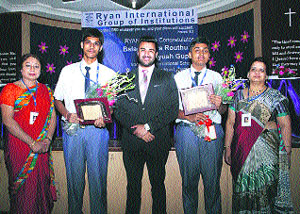 Balachandra Routhu and Ayush Gupta, who have discovered an asteroid, being felicitated by Ryan group CEO and school authorities at a function held recently. 