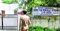 A policeman stands guard outside the home for mentally challenged children in Jammu