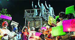 Members of the Taraksheel Society, Punjab, hold a candlelight march in protest against the murder of Dr Narender Dabolkar, a Taraksheel leader of Maharashtra, on the Jagraon bridge