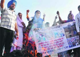 Members of the SSA/RASMA/CSS Teachers Union, Punjab, burn an effigy of the state government in Patiala on Thursday