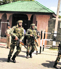 Security personnel patrol the street outside the Shalimar Garden, the venue of the concert, in Srinagar on Friday.