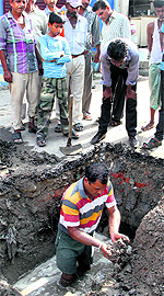 An MC team fixes a leak in a sewerage pipe near the civil dispensary in the Garha area in Jalandhar on Friday