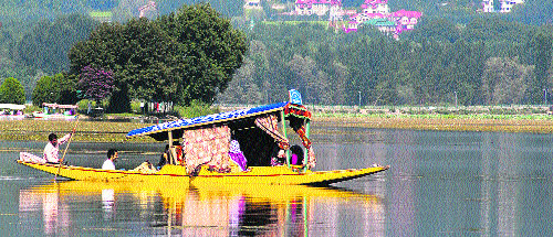 Tourists enjoy a shikara ride on the Dal Lake in Srinagar on Friday.
