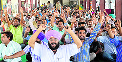 Activists of the Uttariya Railway Mazdoor Union stage a protest at the Ludhiana railway station on Friday