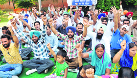 Unemployed linesmen stage a dharna at a park near the Mini-secretariat in Bathinda on Saturday.