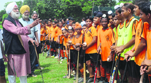 Prof Hardarshan Singh Mejie (L) runs a hockey nursery at Bassi Pathana, where youngsters are trained and given free kits.