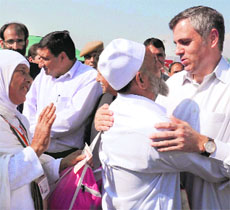 CM Omar Abdullah greets pilgrims leaving for Haj at the Srinagar International Airport on Saturday.