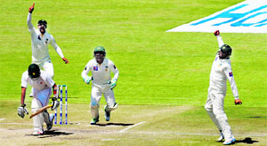 Pakistan fielder Azhar Ali at shortleg (R) celebrates after taking a catch to dismiss Sikanda Raza Butt during the fifth day of the first Test at the Harare Sports Club. 