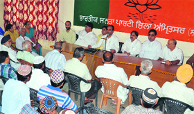 Rakesh Rathore, BJP Amritsar district in-charge, with other party leaders during a meeting in Amritsar on Sunday.