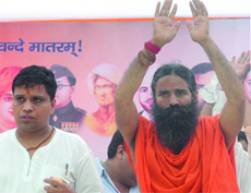 Yoga guru Baba Ramdev with his close associate Acharya Balkrishna during the Vyavastha Parivartan rally at Jantar Mantar in New Delhi on Sunday.