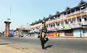 A security personnel patrols the Lal Chowk area in Srinagar