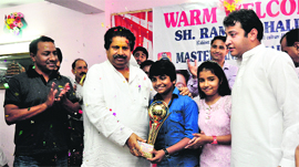 Minister for Housing and Culture Raman Bhalla felicitates Indian Idol junior finalist Anmol Jaswal in Jammu on Sunday.