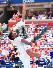 Leander Paes lifts his partner Radek Stepanek after beating Alexander Peya/Bruno 6-1, 6-3 for the US Open doubles trophy, on Sunday.