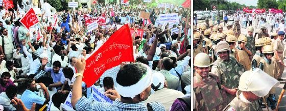 Members of the Sarv Karamchari Sangh, Haryana, hold a protest at the Chandigarh-Panchkula border on Monday; and (right) Haryana Police personnel keep a vigil .