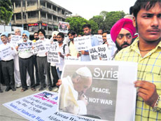 CPI (ML) members hold a protest against the US plan to attack Syria, in Sector 17, Chandigarh, on Monday. 