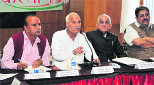 Pradesh Congress Committee vice-president Chander Kumar addresses party workers during a state executive meeting in Shimla on Monday. 