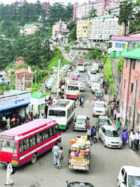 Vehicles stuck in a long traffic jam near the old bus stand in Shimla on Monday. 