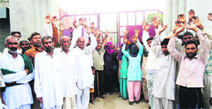 Residents of Bhirtana village in Jind protest after locking the main gate of the Government Middle School on Monday in protest against the shortage of staff. 