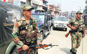 Paramilitary troops stand guard during a curfew in Muzaffarnagar on Monday.