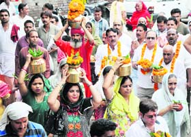 Devotees take out a kalash yatra on the occasion of Ganesh Chaturthi, marking the beginning of the nine-day Ganesh Mahotsava in Jammu on Monday