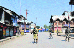 CRPF jawans patrol the curfew-bound Shopian on Monday. Tribune photo: Amin War