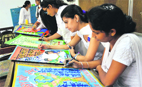 Girls participate in a poster-making competition during International Literacy Day in Ludhiana.