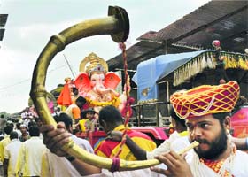 Devotees carry a Lord Ganesha idol to a pandal on the occasion of Ganesh Chaturthi in Karad, Maharashtra, on Monday