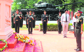 An Army officer pays homage to martyrs at a war memorial in Patiala on Monday.