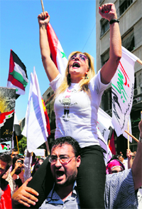 A protester takes part in a rally to show support to Syrian President Bashar al-Assad in Damascus on Monday.