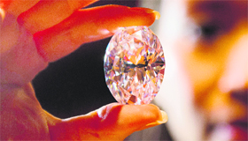 A Sothebys auction house employee holds the greatest white diamond to ever appear at an auction on Monday. It is the largest D colour flawless diamond and will be offered for sale in Hong Kong on October 7.