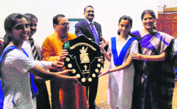 Welham Girls School team lifts the All India Kashi Naresh Hindi Debate Trophy in Dehradun on Tuesday. A Tribune photograph