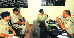 Garhwal DIG Amit Sinha holds a meeting of police officials at Roshanabad on Tuesday. 