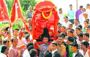 Devotees carry local diety Mostas idol in a palanquin during the annual mela in the Mostamanu area of Pithoragarh district on Tuesday