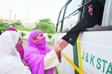 A pilgrim greets her relatives before leaving for Haj at the Haj House in Jammu on Tuesday. 