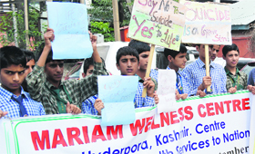 Schoolchildren hold placards during a rally on World Suicide Prevention Day in Srinagar on Tuesday.