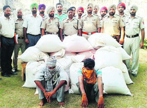 Drug peddlers with the seized poppy husk in police custody at Jagraon. 