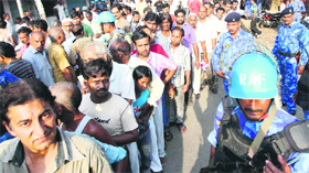 People queue up to collect daily supplies as curfew was relaxed in Muzaffarnagar on Tuesday.