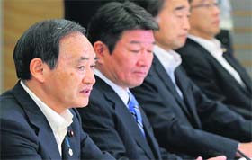 Japan's Chief Cabinet Secretary Yoshihide Suga (L) speaks at the first Cabinet meeting on decommissioning nuclear reactors and control of radiation-contaminated water leak at the Fukushima plant, in Tokyo on Tuesday