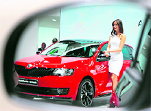 A model presenting a Skoda Rapid is refelected in a rear view mirror of a car at the IAA (Internationale Automobil Ausstellung) in Frankfurt on Wednesday. More than 1,000 exhibitors from 35 countries will present their products during the show running from September 12 to 22