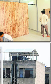 Workers give the final touches to a sample flat; and a solar panel installed on a flat at Dhanas. 