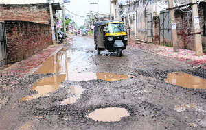 A potholed road near the LIC Colony in Kharar.