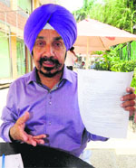 Traffic marshal Jagdish Singh Sarpal shows his complaint in Chandigarh on Wednesday. 