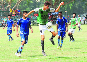 Players in action during an inter-college football tournament at the Punjab University grounds in Chandigarh on Tuesday.